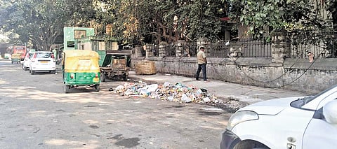 A man urinates on the footpath on Dhanvantri Road in Majestic