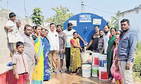 Residents gather to collect drinking water from a tanker at Annaram village