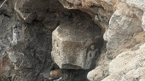 An ancient stone sculpture unearthed during excavation for a roadside drainage canal on the newly widened main road in Vemulawada town on December 26