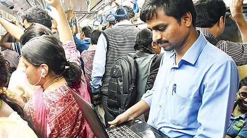 A laptop-borne rider in Namma Metro