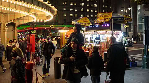 People walk past Grand Central terminal, Monday, Dec. 22, 2025, in New York.