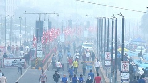 Early-morning walkers and joggers at RK Beach amid air quality concerns in Visakhapatnam.
