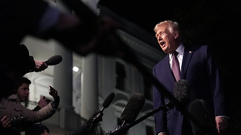 US President Donald Trump talks to the media as he walks to Marine One from the White House, Friday, Dec. 19, 2025, in Washington.