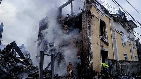 A man walks from a house destroyed after a Russian strike on Kyiv, Ukraine, on Saturday, Dec. 27, 2025