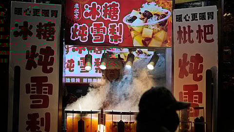 A vendor sells hot drinks in Beijing, Thursday, Dec. 18, 2025.