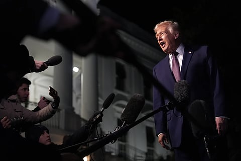 President Donald Trump talks to the media as he walks to Marine One from the White House, Friday, Dec 19, 2025, in Washington.