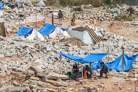 People stay at make-shift tents, amidst the rubble caused by the demolition drive by BSWML at Kogilu Layout