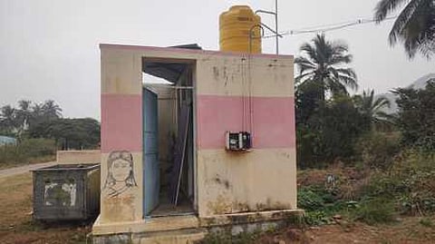 A community sanitary complex with damaged doors in Moongilpatti village of Chikkapoovathi panchayat in Krishnagiri district.