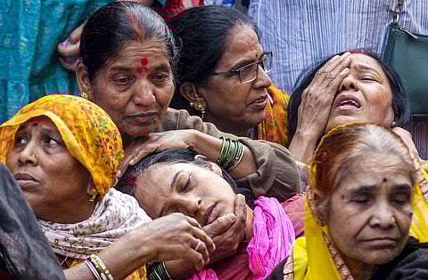 Family members of a victim, who died after consumption of allegedly contaminated water, mourn in the Bhagirathpura area of Indore, Madhya Pradesh.