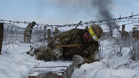 In this photo provided by Ukraine's 65th Mechanized Brigade press service, recruits perform drills at a training ground in the Zaporizhzhia region, Ukraine, Thursday, Jan. 1, 2026.
