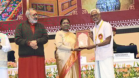 V K Jayan receiving the award