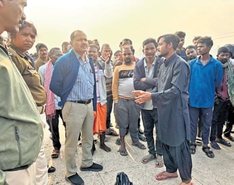 Police officials holding a discussion with locals at the mishap site.