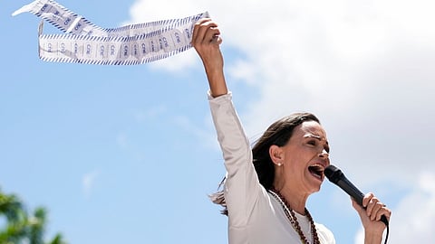 Opposition leader Maria Corina Machado holds up tally sheets during a protest against the reelection of President Nicolás Maduro one month after the disputed presidential vote which she says the opposition won by a landslide, in Caracas, Venezuela, Aug. 28, 2024.