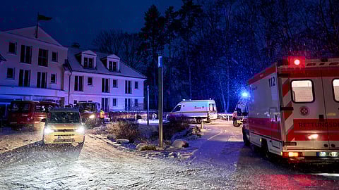 Emergency vehicles from the aid organization "Die Johanniter" pick up residents of a retirement home in Berlin, Germany, Saturday, Jan. 3, 2025, during a power cut in south-west Berlin after a fire on a cable bridge.