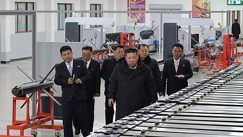 In this photo provided by the North Korean government, its leader, Kim Jong Un, front right, visits a major munitions factory at an undisclosed place in North Korea on Saturday, Jan. 3, 2026.