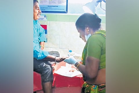 A video grab of a multipurpose health worker stitching the wound at Kalavai government hospital