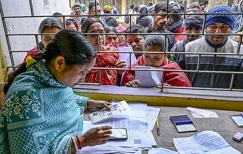 People wait at a centre during hearings for the Special Intensive Revision (SIR) of the electoral rolls, in Nadia, West Bengal.