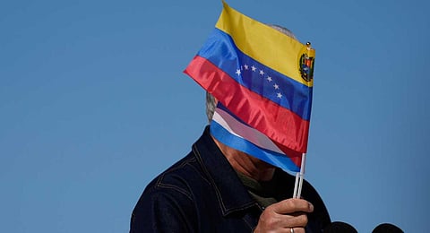 Cuban President Miguel Diaz-Canel waves Venezuelan and Cuban national flags during a rally in Havana, Saturday, Jan. 3, 2026, in solidarity after the U.S. captured President Nicolas Maduro and flew him out of Venezuela.