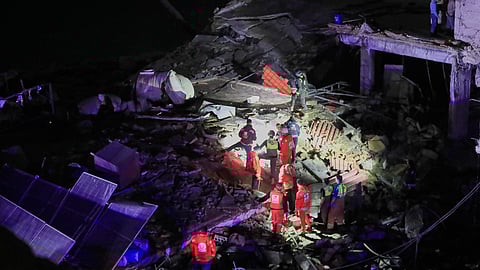 Rescue workers search for possible victims in a building destroyed by an Israeli airstrike in the southern port city of Sidon, Lebanon, early Tuesday, Jan. 6, 2026.