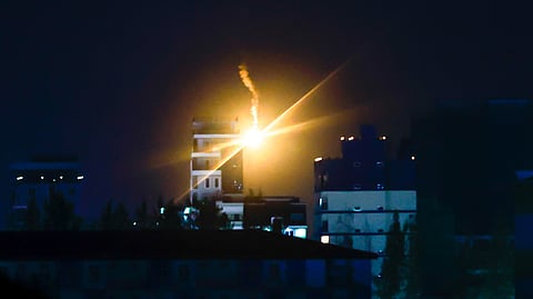 In this photo from Dec. 26, 2025, Thai military forces fire illumination flares in Poipet, Cambodia, as seen from Sa Kaeo, Thailand, following clashes between Thai and Cambodian soldiers.