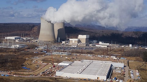 A data center owned by Amazon Web Services, front right, is under construction next to the Susquehanna nuclear power plant in Berwick, Pennsylvania
