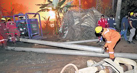 Firefighters pump water from nearby irrigation canals, flames significantly reduced at gas leak site.