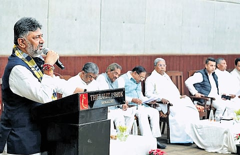 Deputy CM DK Shivakumar addresses a meeting of Congress elected representatives in Bengaluru on Thursday. CM Siddaramaiah and others look on