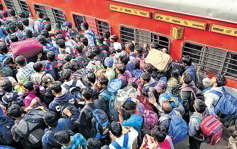 Passengers rush to enter the train at Secunderabad as they leave from Hyderabad to their native places on Saturday ahead of Sankranti