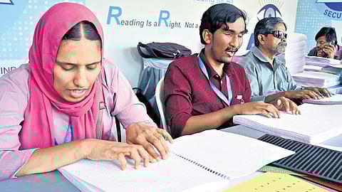 Visually impaired members of the Kerala Federation of the Blind playing chess at the stall set up as part of the Kerala Legislature International Book Festival at the assembly