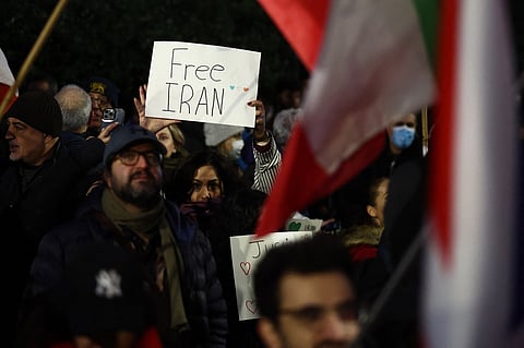 An anti-Iranian regime protester holds up a "Free Iran" placard during a gathering outside the Iranian Embassy, central London, on January 9, 2026.