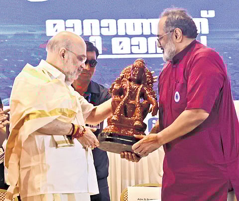 BJP state president Rajeev Chandrasekhar presents Union Home Minister Amit Shah an idol of Lord Ayyappa at the Uday Palace Convention Centre, Kowdiar, in Thiruvananthapuram on Sunday