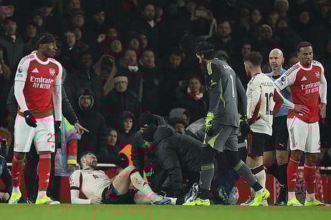 Trainers check on Liverpool's Conor Bradley during the English Premier League soccer match between Arsenal and Liverpool in London, Thursday, Jan. 8, 2026.