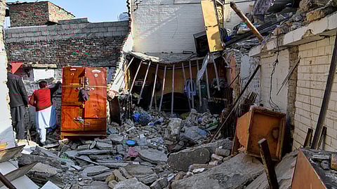 Government officials survey the damage of a home caused by a gas cylinder explosion hours after a wedding reception in Islamabad, Pakistan, Sunday, Jan. 11, 2026.