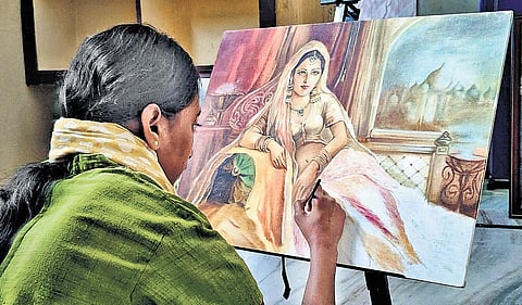 Dhanalakshmi at work on a canvas at her home in Villupuram district