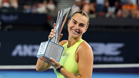 Aryna Sabalenka of Belarus poses with the winners trophy after winning the women's final match against Marta Kostyuk of Ukraine 6-4, 6-3, at the Brisbane International tennis tournament in Brisbane, Australia, Sunday, Jan. 11, 2026.