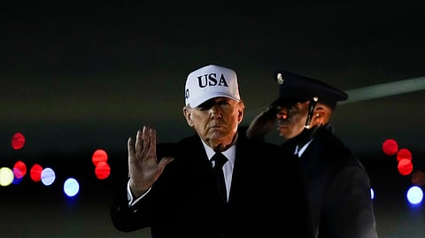 President Donald Trump waves after arriving on Air Force One from Florida, Sunday, Jan. 11, 2026, at Joint Base Andrews, Md.