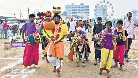 Artistes bring Sankranti tradition alive in Vijayawada on Monday.