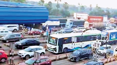 Vehicles queue at the Panthangi toll plaza on Tuesday