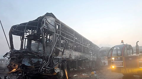 Cranes clear the charred remains of buses after a fog-hit pile-up involving several buses and cars triggered fires on the Yamuna Expressway, in Mathura, Tuesday, Dec. 16, 2025.