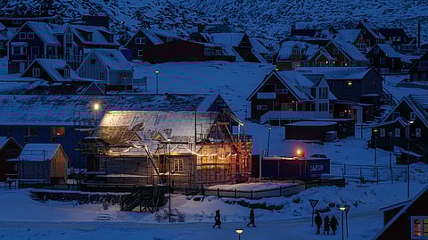 People walk along a street in downtown of Nuuk, Greenland, on Tuesday, Jan. 13, 2026.