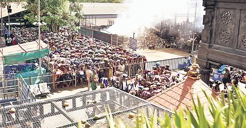 Devotees wait to climb the holy steps at Sabarimala on Thursday.