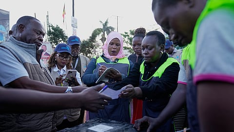 Voters observe the opening of ballot papers during the presidential election in Kampala, Uganda, Thursday, Jan. 15, 2026.