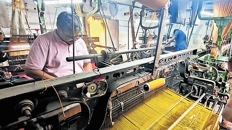 KC Dwarakish weaves 20 metres of cloth a day on one of his looms.