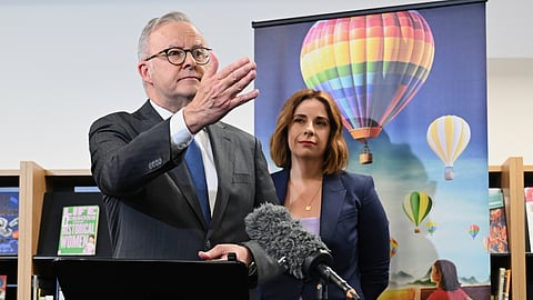 Australian Prime Minister Anthony Albanese, left, and Australian Communications Minister Anika Wells speak to the media during a visit to St John Paul II College in Canberra, Australia, on Dec. 11, 2025.