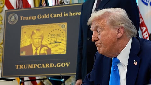 A poster showing the Trump Gold Card is seen as US President Donald Trump signs executive orders in the Oval Office of the White House, Sept. 19, 2025, in Washington.