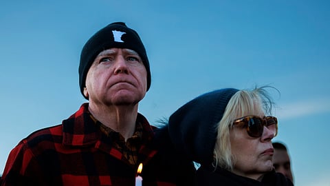 Minnesota Gov. Tim Walz and his wife, Gwen Walz, attend a vigil honouring Renee Good on Friday, Jan. 9, 2026, in St. Paul, Minn., outside the Minnesota State Capitol.