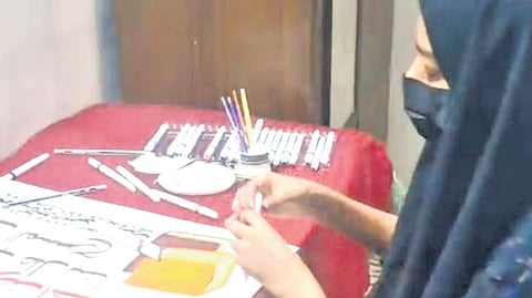 Siya Fathima designing her poster during the school kalolsavam