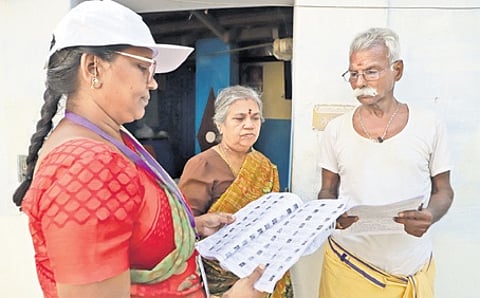 Booth Level Officers verifying residents' names with the draft electoral roll in Tamil Nadu.