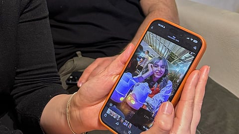 Hali Norei shows a picture of her 23-year-old niece, Robina Aminian, as she gives an interview alongside her partner, Nezar Minoei, in Oslo, Norway, Wednesday, Jan. 14, 2025. Aminian, a university student, was killed during Iran's protests.