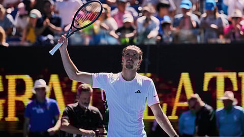 Alexander Zverev of Germany waves after defeating Gabriel Diallo of Canada in their first round match at the Australian Open tennis championship in Melbourne, Australia, Sunday, Jan. 18, 2026.